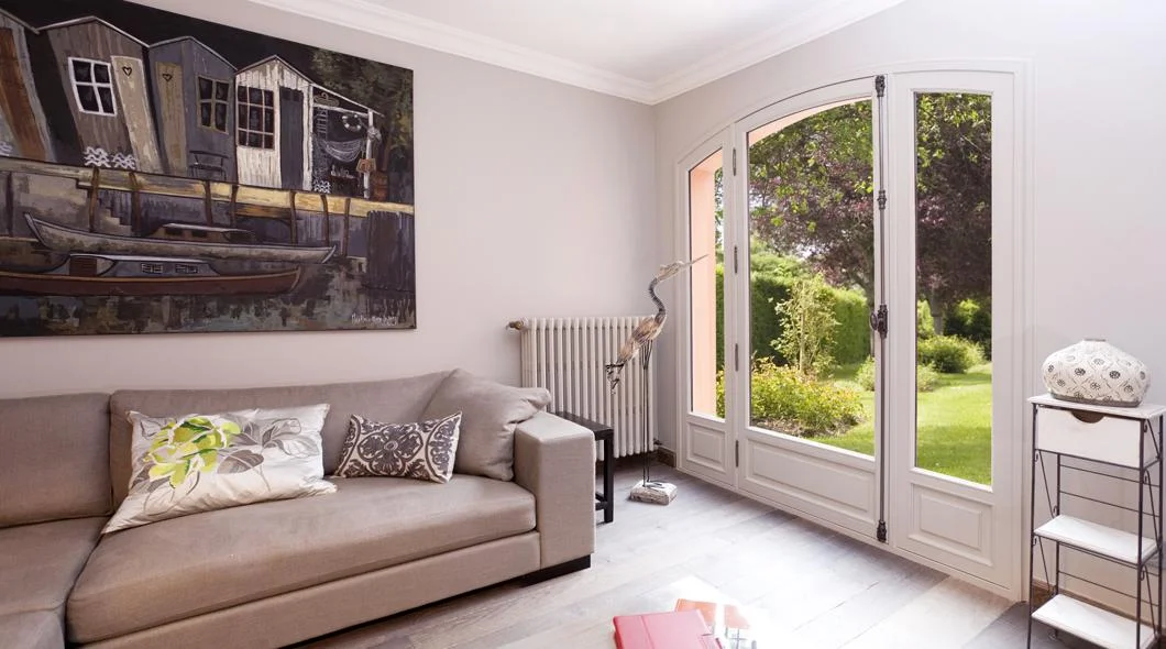 Porte-fenêtre à deux vantaux ouverte sur un jardin depuis un salon à La Souterraine